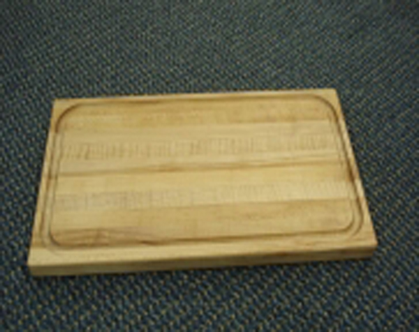 Wood mouldings and dimension made into a rectangular wooden cutting board with juice catcher